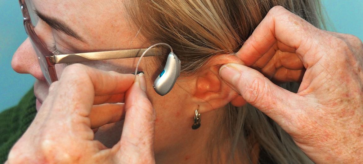 A woman being fitted for a receiver-in-canal (RIC) hearing aid. A woman being fitted for a receiver-in-canal (RIC) hearing aid.