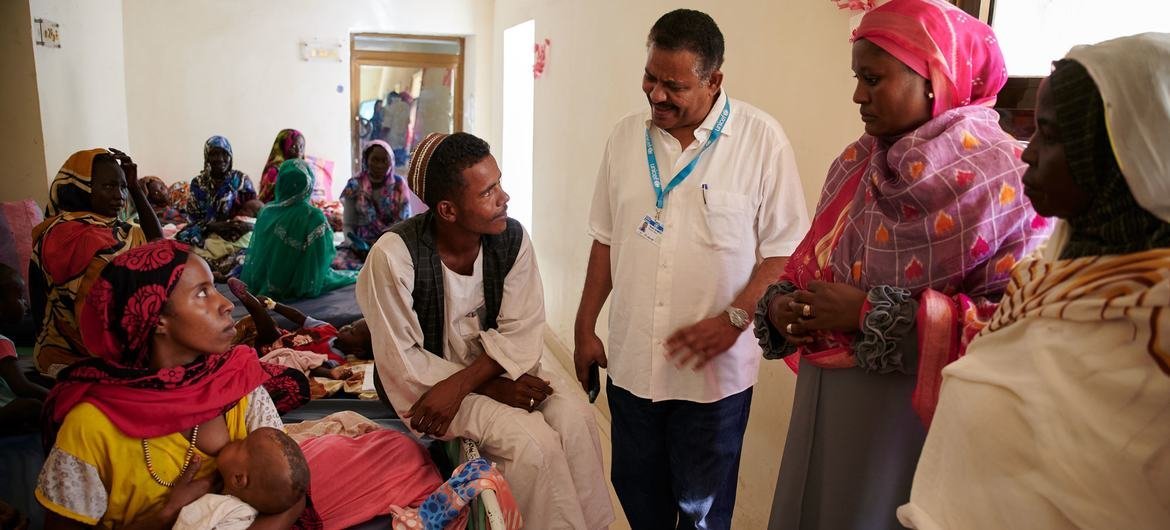 A doctor speaks to a family in a health facility for severe malnutrition in Sudan. A doctor speaks to a family in a health facility for severe malnutrition in Sudan.