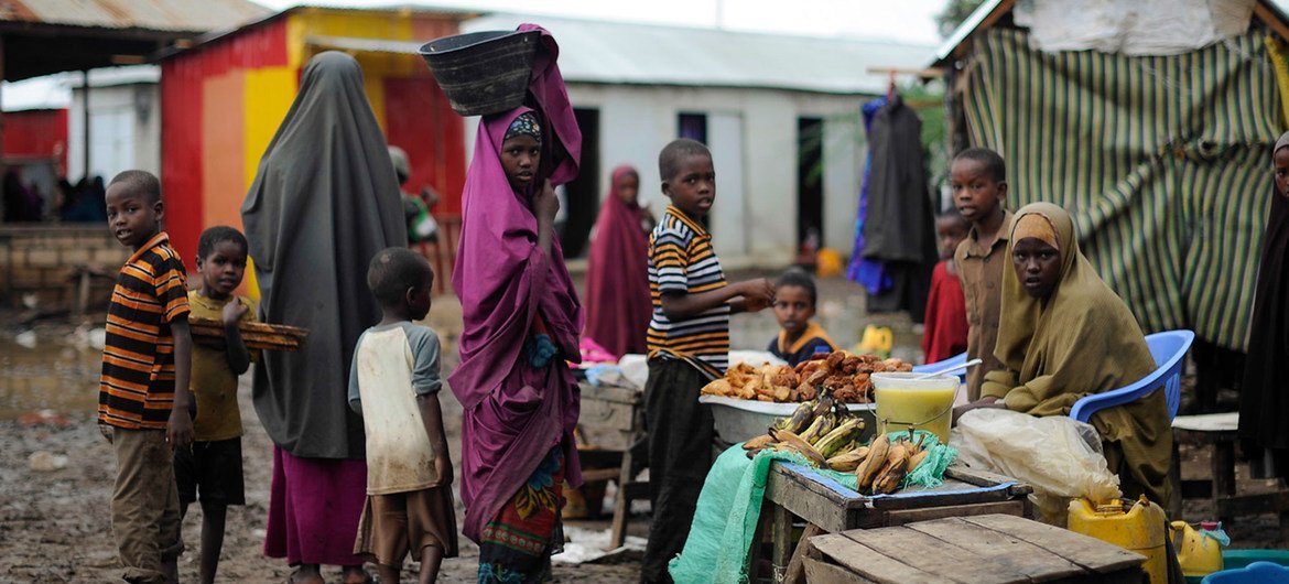 Women and children at a market stand in Kurtunwaarey , Somalia. Women and children at a market stand in Kurtunwaarey , Somalia.