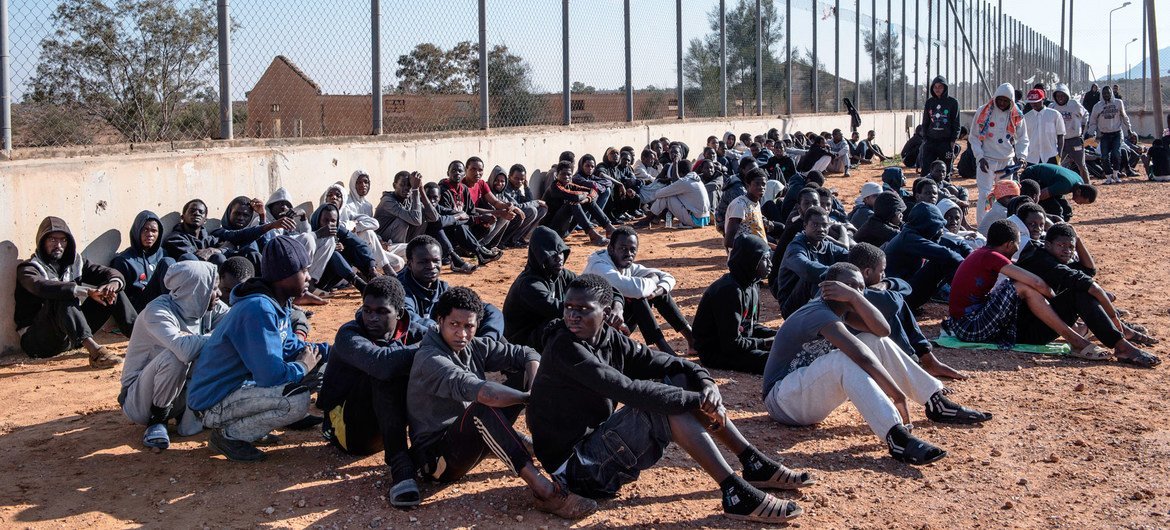 Migrants sit in the courtyard of a detention centre in Libya. (file) Migrants sit in the courtyard of a detention centre in Libya. (file)