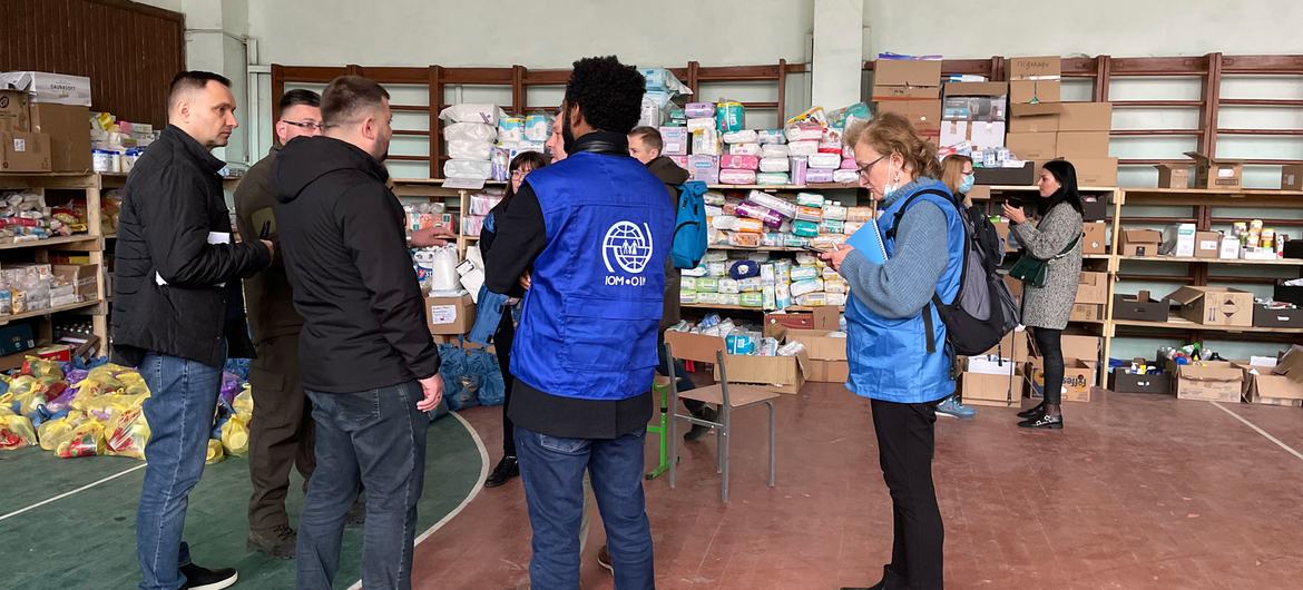 IOM staff at the school gym in the village of Bushtyno, where the local community stocks supplies for internally displaced people...