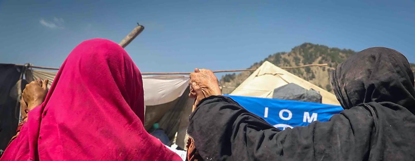 A group of women holds hands as they breathe in deeply, guided by an IOM psychosocial counsellor. A group of women holds hands as they breathe in deeply, guided by an IOM psychosocial counsellor.