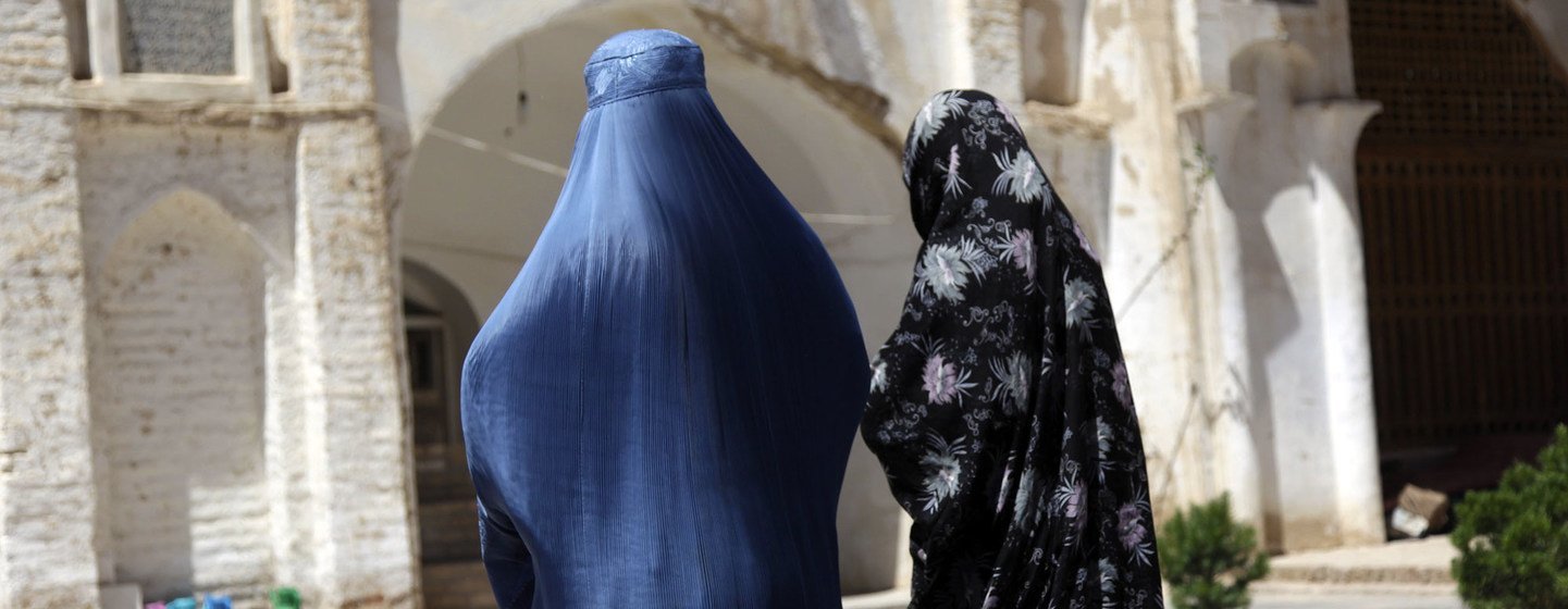 Two Afghan women walk near an ancient mosque in western Herat province. Two Afghan women walk near an ancient mosque in western Herat province.
