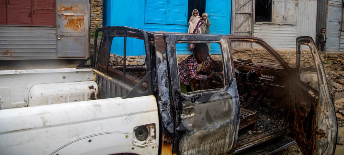 A child sits inside a burned vehicle during fighting in the Tigray region, northern Ethiopia.
