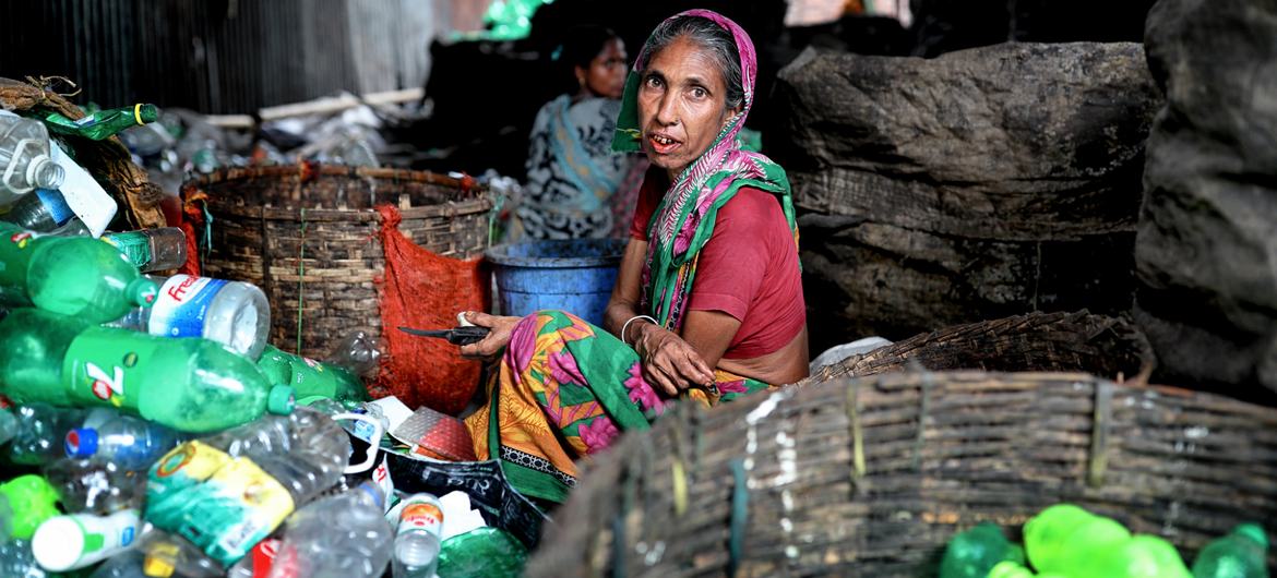 A woman works in a plastic recycling factory in Bangladesh. A woman works in a plastic recycling factory in Bangladesh.