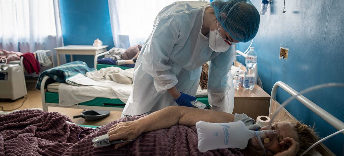 A health worker checks a COVID patient's condition at a hospital in Kharkiv, Ukraine. A health worker checks a COVID patient's condition at a hospital in Kharkiv, Ukraine.