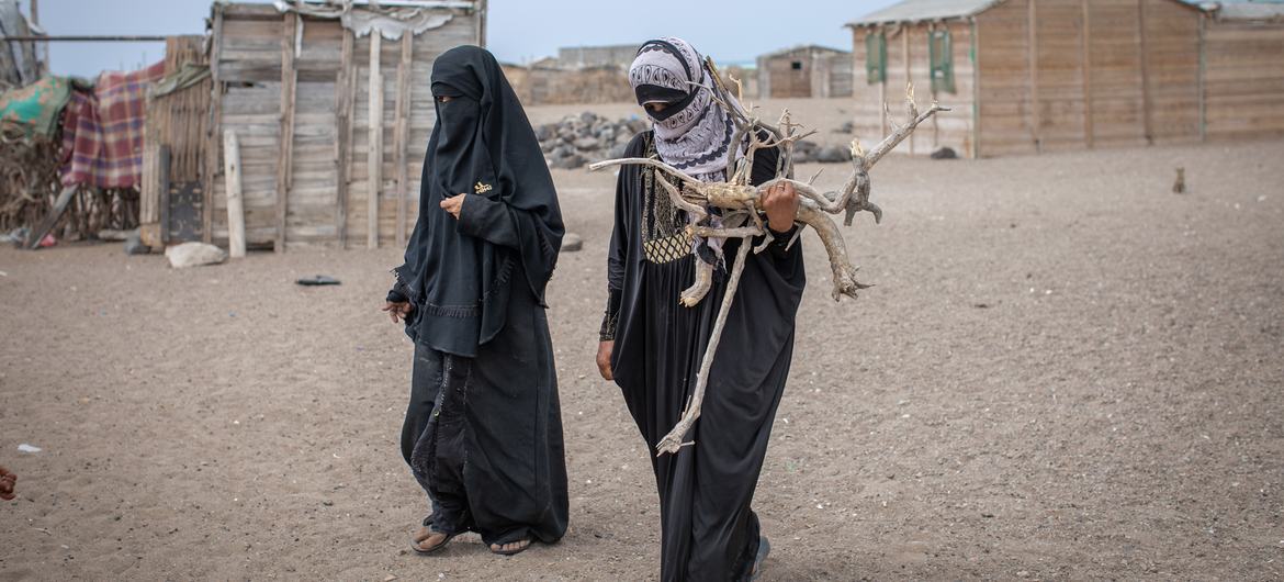 Two women collect wood for cooking in Mokha, Yemen.