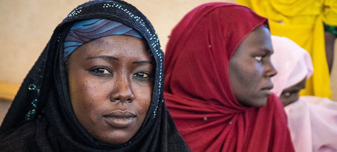 Two displaced women sit at a camp in Awaradi, Niger. Two displaced women sit at a camp in Awaradi, Niger.
