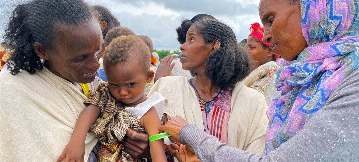 A young child is screened for malnutrition at a food distribution site in Tigray, northern Ethiopia. A young child is screened for malnutrition at a food distribution site in Tigray, northern Ethiopia.