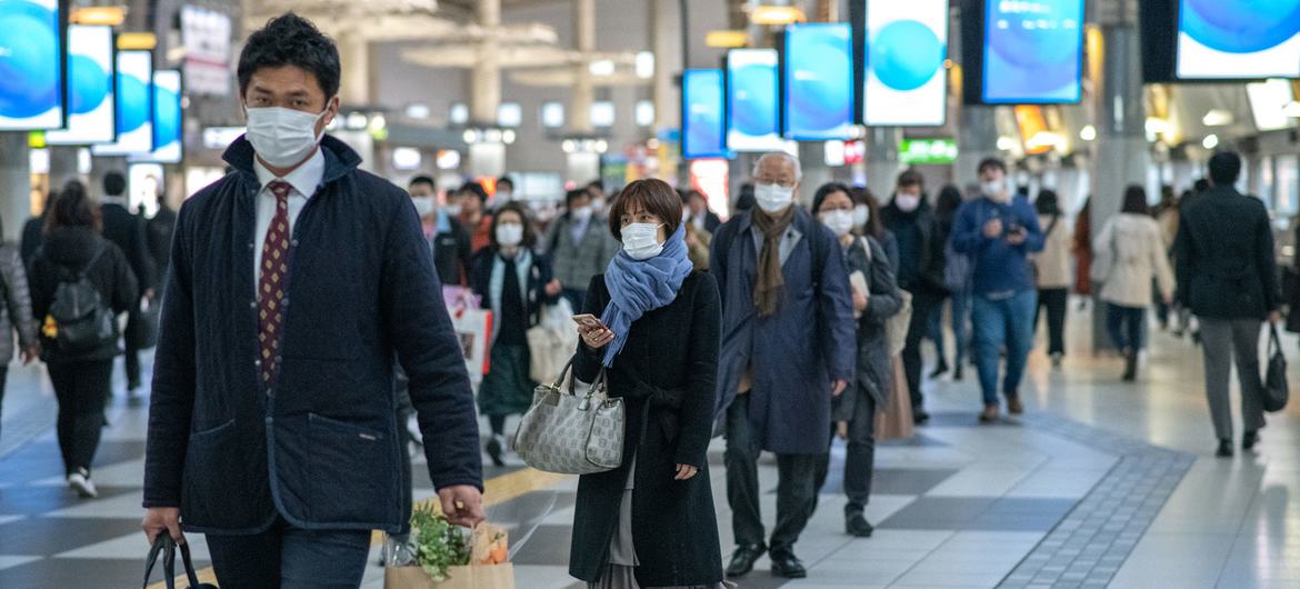 Commuters wear protective masks in Shinagawa, Tokyo. Commuters wear protective masks in Shinagawa, Tokyo.