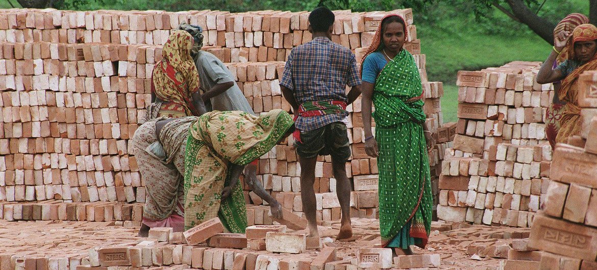Workers stack bricks at a factory near Dhaka in Bangladesh. Workers stack bricks at a factory near Dhaka in Bangladesh.
