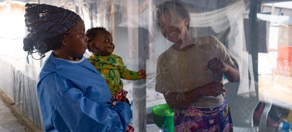 A five-month-old baby smiles when he sees his mother through the plastic that separates them at an Ebola Treatment Centre (ETC) in Beni, North Kivu province, Democratic Republic of the Congo. A five-month-old baby smiles when he sees his mother through the plastic that separates them at an Ebola Treatment Centre (ETC) in Beni, North Kivu province, Democratic Republic of the Congo.