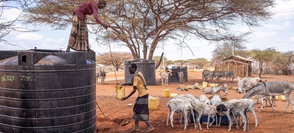 A man collects water from a water tank in Kenya. A man collects water from a water tank in Kenya.