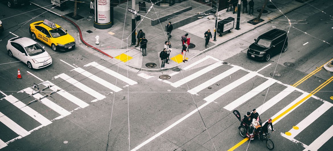 People wait for a light change at a pedestrian crossing in San Francisco, in the United States. People wait for a light change at a pedestrian crossing in San Francisco, in the United States.