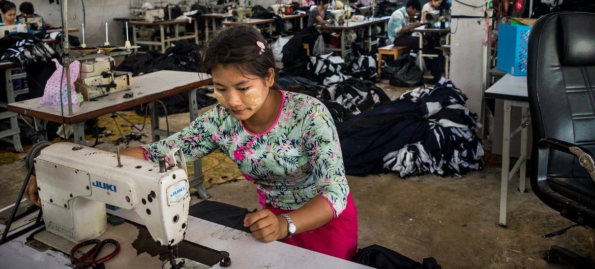 A migrant worker sews clothes in a factory in western Thailand. A migrant worker sews clothes in a factory in western Thailand.