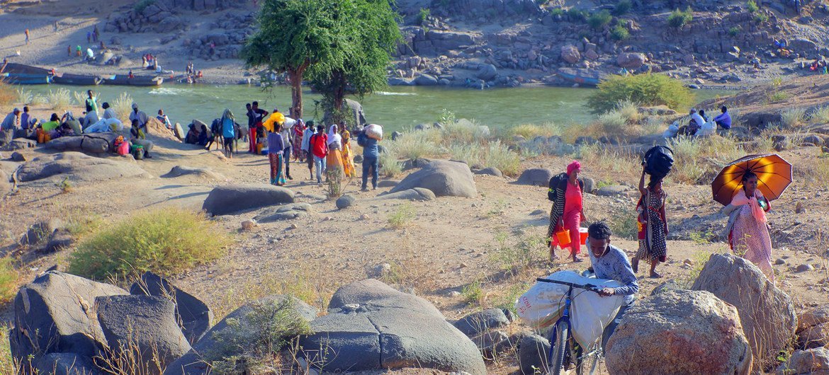 Ethiopian refugees, fleeing clashes in the country's northern Tigray region, cross the border into Hamdayet, Sudan, over the Tekeze river. Ethiopian refugees, fleeing clashes in the country's northern Tigray region, cross the border into Hamdayet, Sudan, over the Tekeze river.