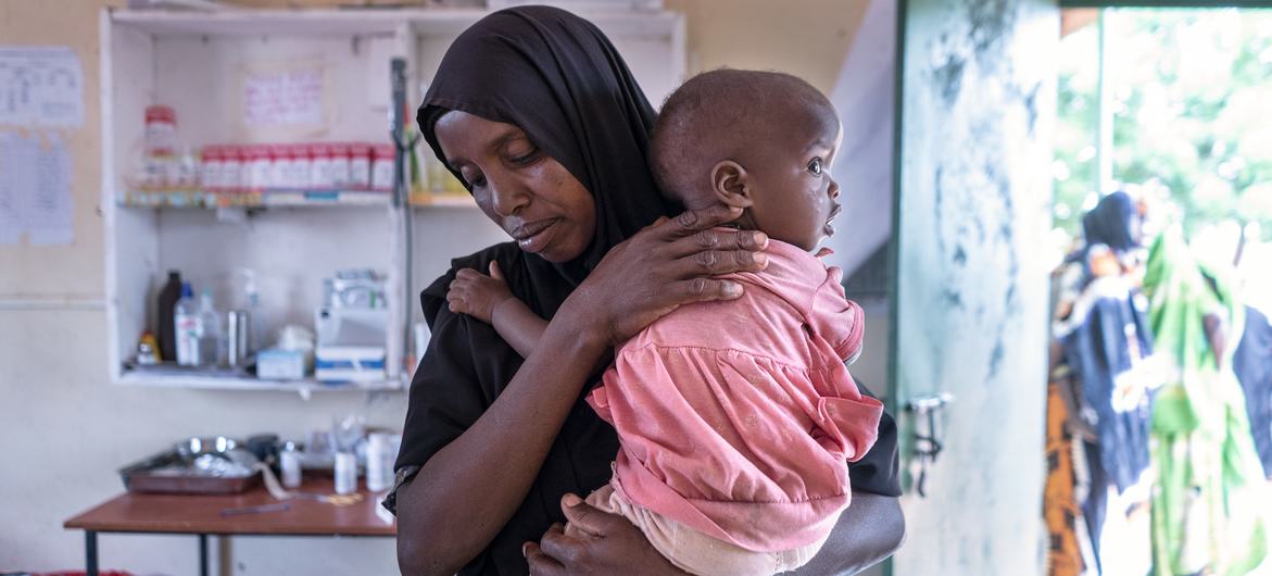 A mother in Wajir, Kenya brings her child to a health centre to be weighed. A mother in Wajir, Kenya brings her child to a health centre to be weighed.