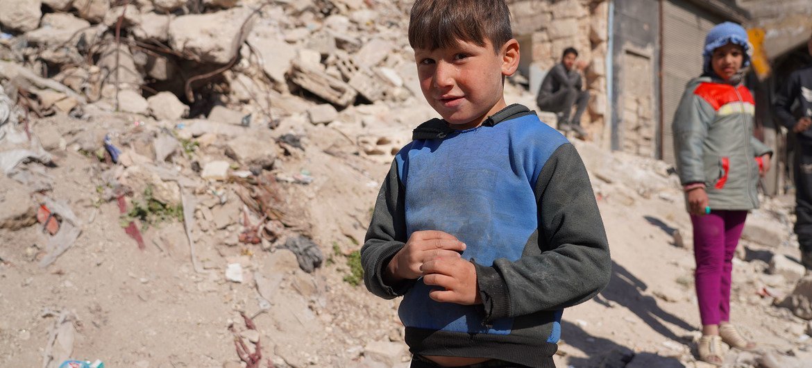 Children wait for food distribution during the COVID-19 crisis in Aleppo, Syria.