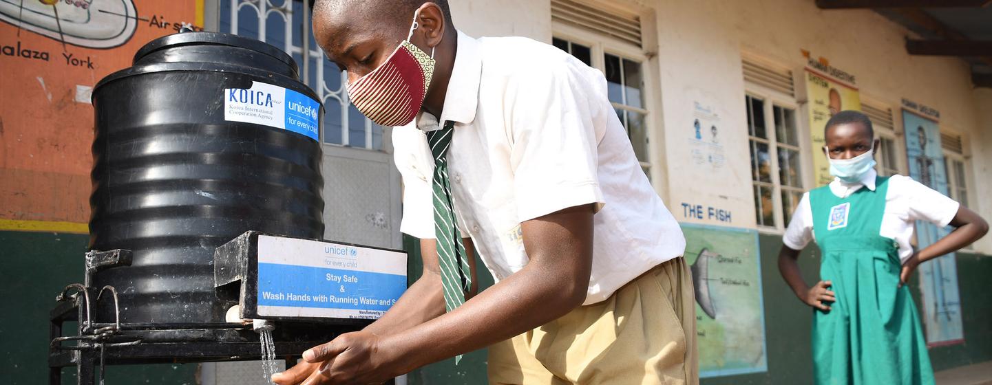 Mukasa Herbert a pupil at Nakivubo Settlement Nursery and Primary School in Uganda washes his hands on day one of school reopening, January 10th 2022. Mukasa Herbert a pupil at Nakivubo Settlement Nursery and Primary School in Uganda washes his hands on day one of school reopening, January 10th 2022.