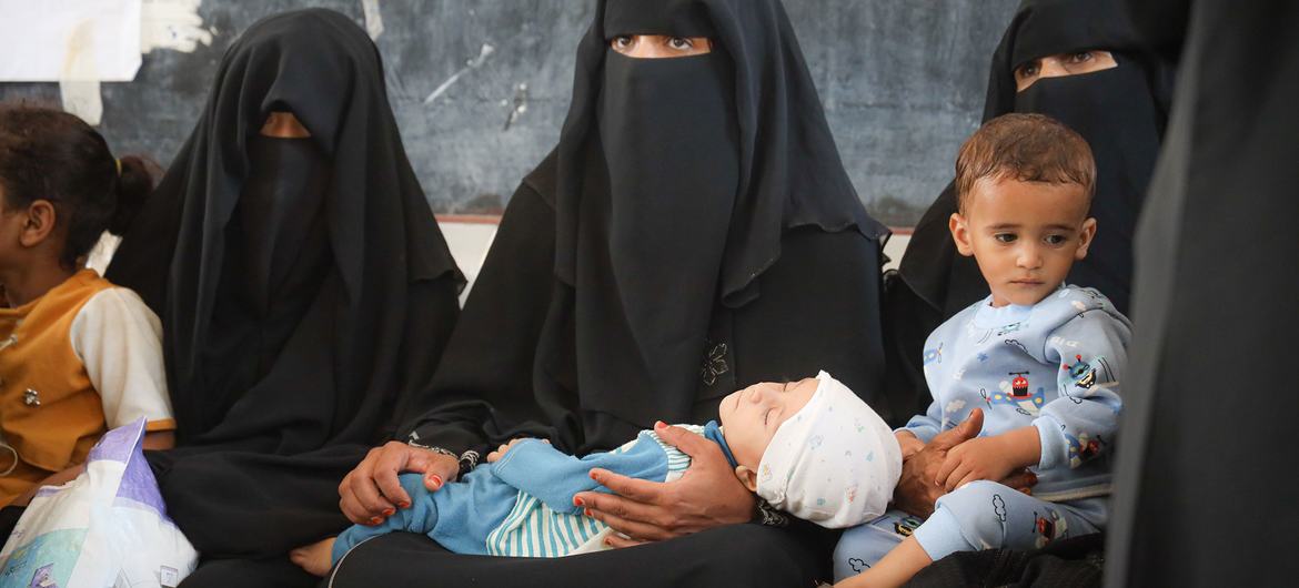Anneler, çocuklarını, Taiz, Yemen'deki yetersiz beslenme önleme tedavisi için WFP destekli bir kliniğe getiriyor.