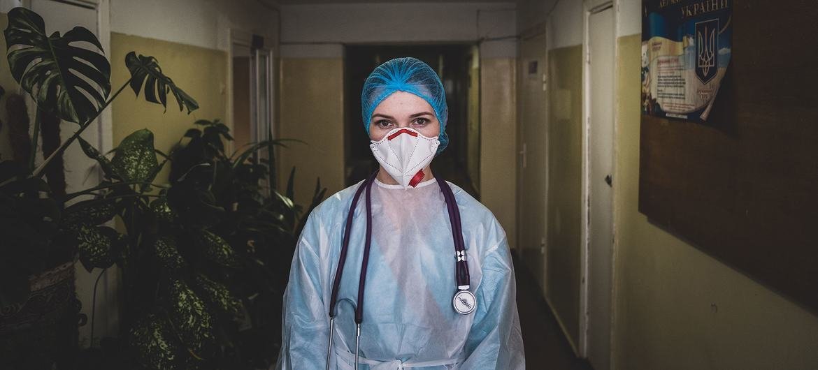 A healthcare worker wears PPE at a hospital in Kharkiv, Ukraine, where she takes care of patients who are severely ill with COVID. A healthcare worker wears PPE at a hospital in Kharkiv, Ukraine, where she takes care of patients who are severely ill with COVID.