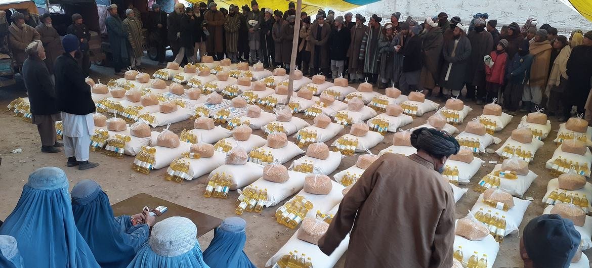 People wait in line for food and oil being distributed by the World Food Programme in Andkhoy, Afghanistan. People wait in line for food and oil being distributed by the World Food Programme in Andkhoy, Afghanistan.