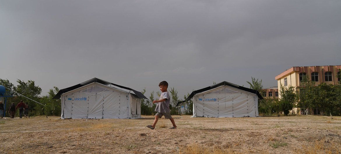 A child walks through a temporary camp set up in Kabul after his family was displaced due to insecurity across Afghanistan. A child walks through a temporary camp set up in Kabul after his family was displaced due to insecurity across Afghanistan.
