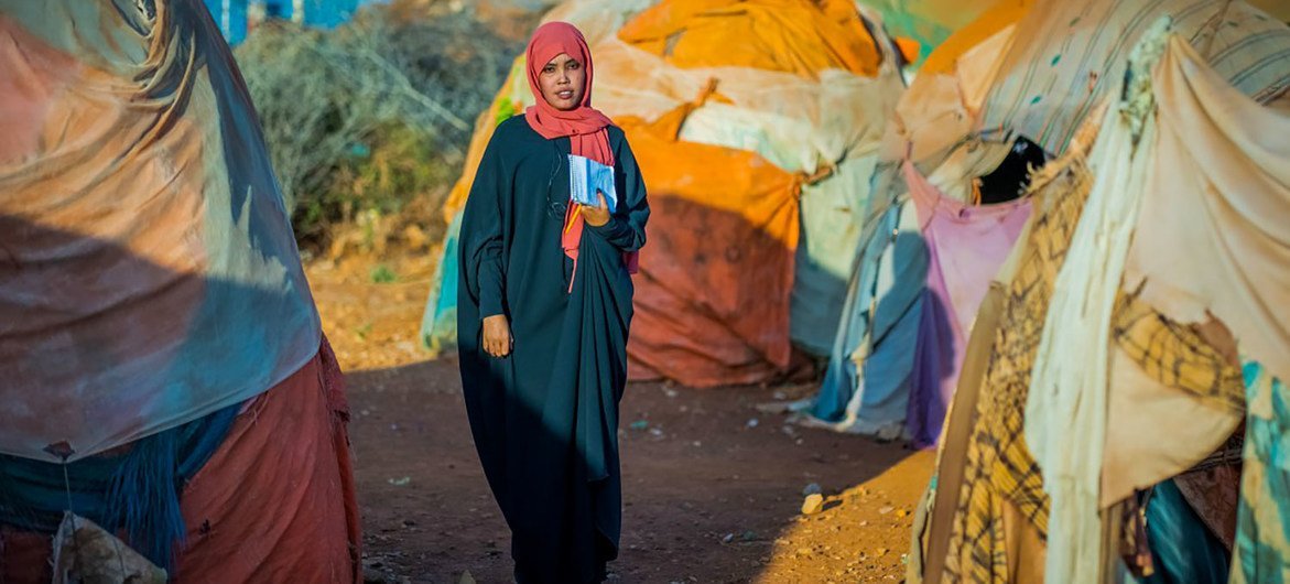 A case worker at a camp for internally displaced people in Somalia helps abused women get medical care. A case worker at a camp for internally displaced people in Somalia helps abused women get medical care.