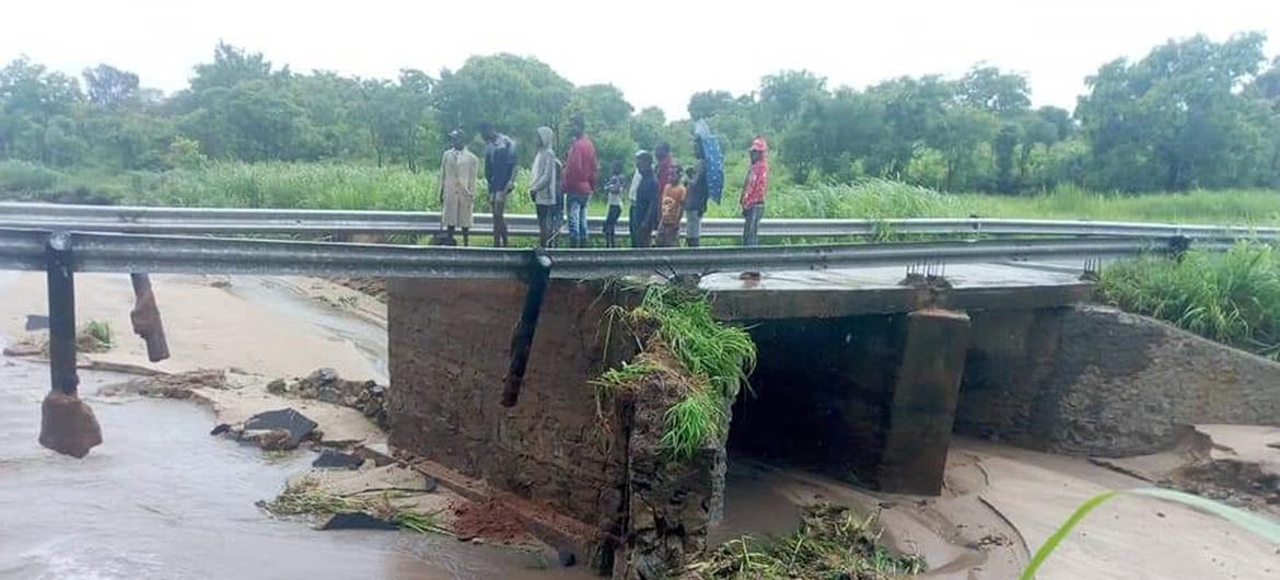 People stand on a damaged bridge in the aftermath of Tropical Storm Ana making landfall in Mozambique. People stand on a damaged bridge in the aftermath of Tropical Storm Ana making landfall in Mozambique.