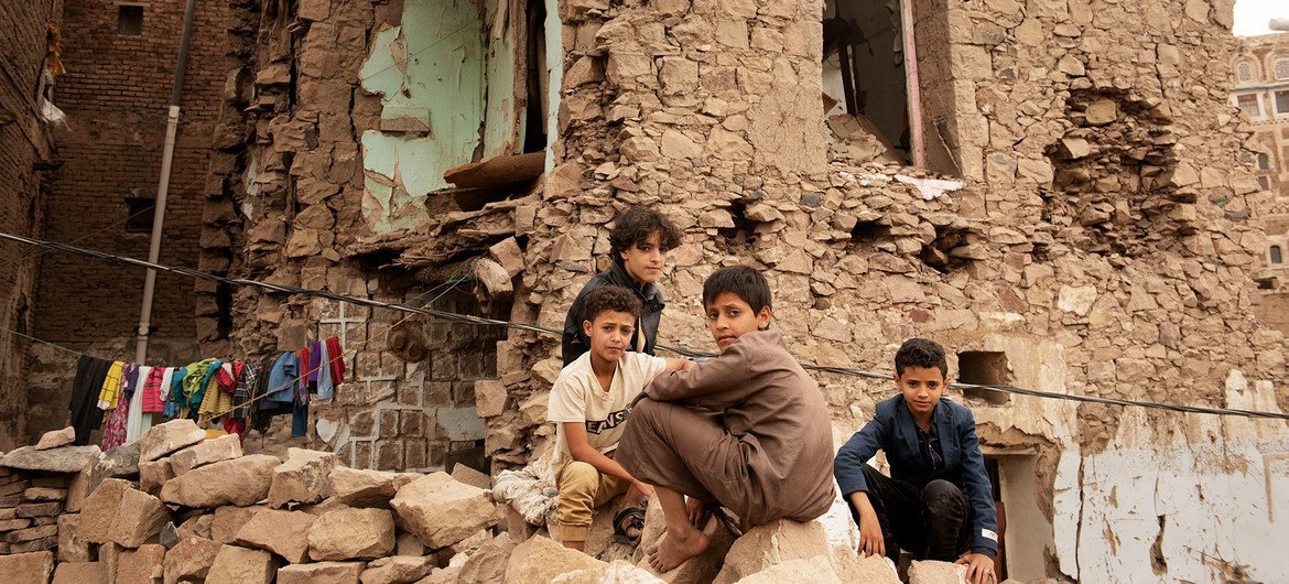 Children sit in front of a house damaged by an air strike, inside the old city of Sana'a, Yemen. (file) Children sit in front of a house damaged by an air strike, inside the old city of Sana'a, Yemen. (file)