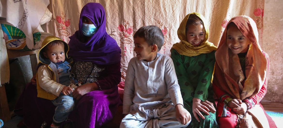 A family sits in their home, in an informal settlement for internally displaced people in Kabul, Afghanistan.