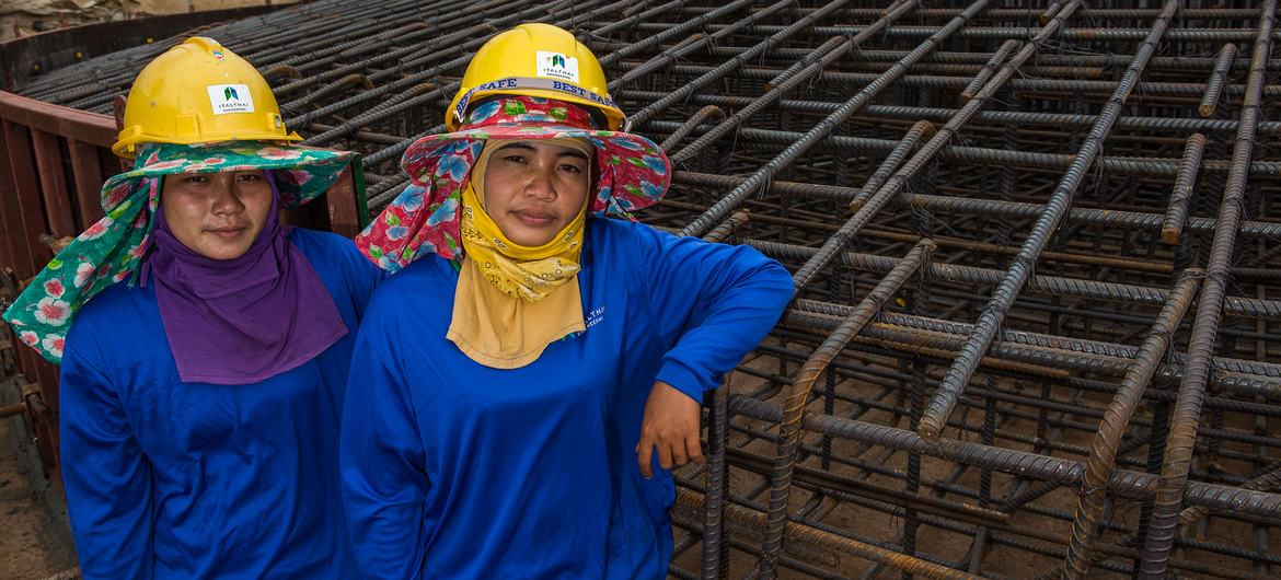 Female construction workers help to build the foundation for a wind farm in Thailand. Female construction workers help to build the foundation for a wind farm in Thailand.