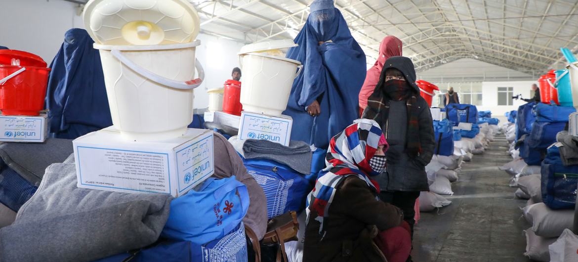 Women and their daughters receive winterization kits from UNICEF in Afghanistan. The kit includes flour, rice, blankets, warm clothes, tarpaulin, and water buckets. Women and their daughters receive winterization kits from UNICEF in Afghanistan. The kit includes flour, rice, blankets, warm clothes, tarpaulin, and water buckets.