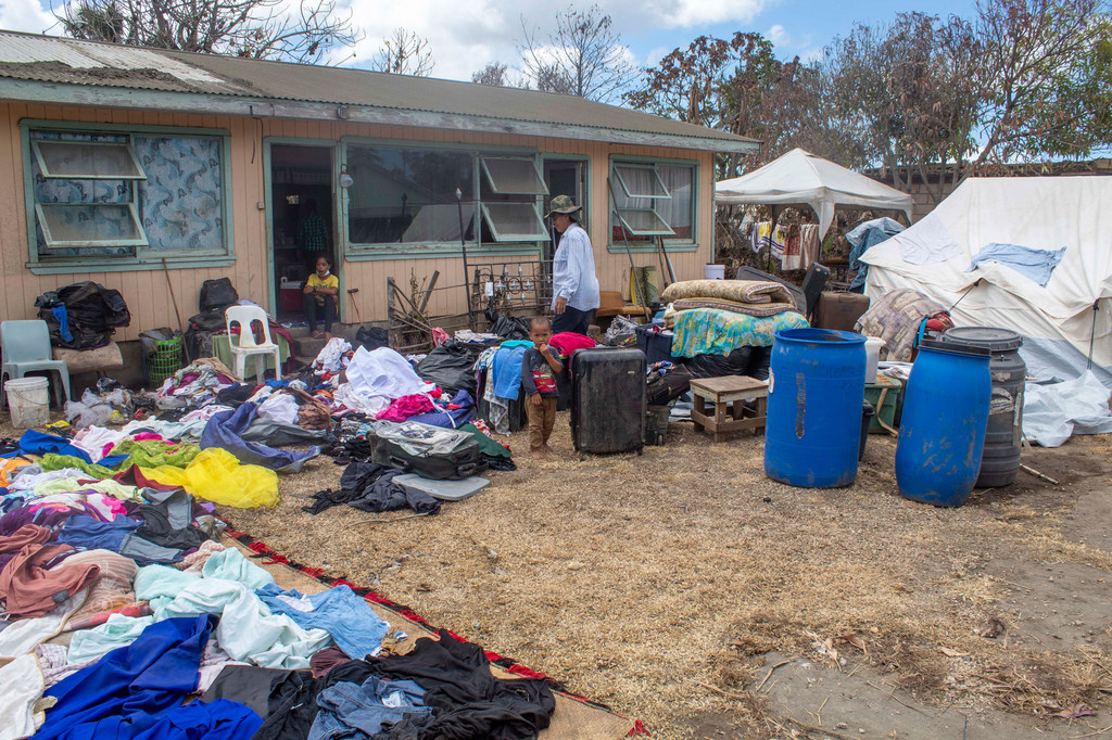 A family dry their belongings outside their home after it was damaged in the Hunga Tonga-Hunga Ha’apai underwater volcano eruption and tsunami. A family dry their belongings outside their home after it was damaged in the Hunga Tonga-Hunga Ha’apai underwater volcano eruption and tsunami.