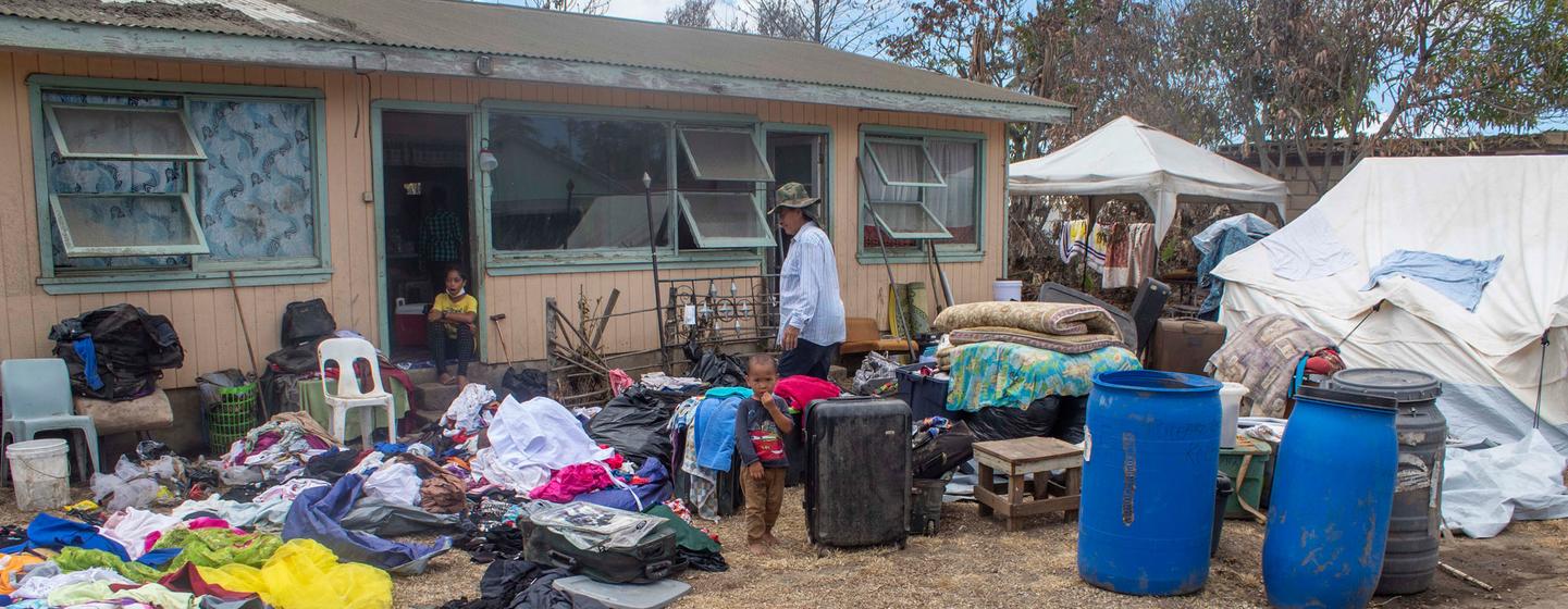 A family dry their belongings outside their home after it was damaged in the Hunga Tonga-Hunga Ha’apai underwater volcano eruption and tsunami. A family dry their belongings outside their home after it was damaged in the Hunga Tonga-Hunga Ha’apai underwater volcano eruption and tsunami.