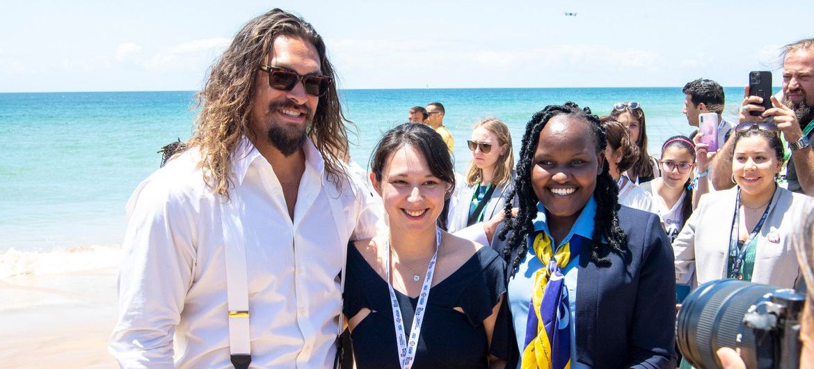 Actor and ocean advocate Jason Momoa (left) meets youth advocates on Carcavelos Beach in Lisbon, Portugal at the UN Ocean Summit.