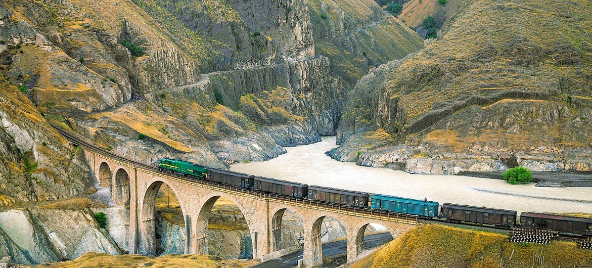 A locomotive freight train traverses the Absirom Bridge on the Trans-Iranian Railway in Iran. A locomotive freight train traverses the Absirom Bridge on the Trans-Iranian Railway in Iran.