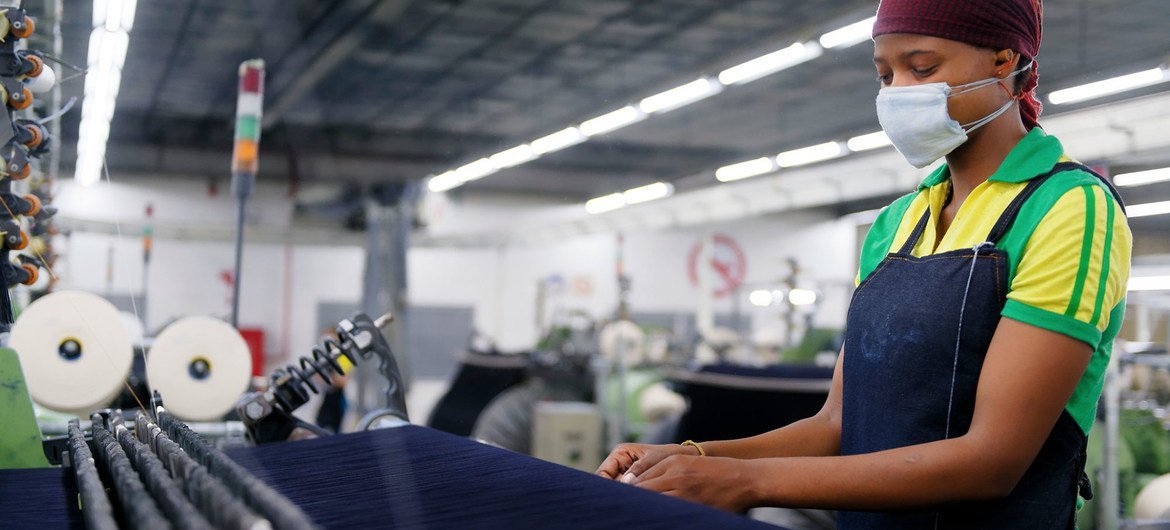 A woman works in a garment factory in Lesotho. A woman works in a garment factory in Lesotho.