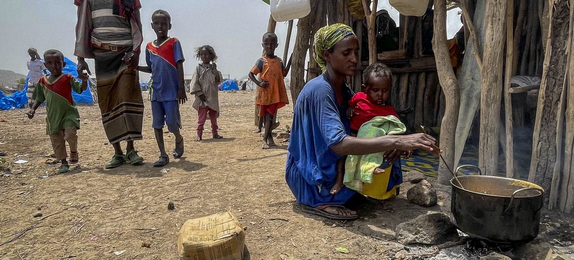 A displaced mother cooks for her family in Afar, Ethiopia. A displaced mother cooks for her family in Afar, Ethiopia.