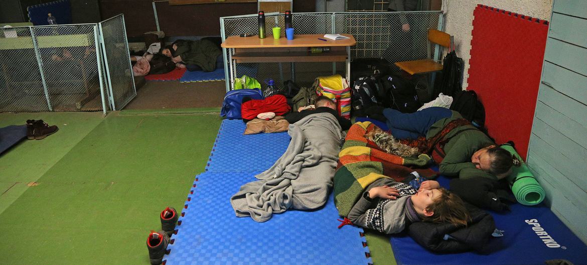 On 25 February 2022, people shelter in a school during ongoing military operations in Kyiv, Ukraine. On 25 February 2022, people shelter in a school during ongoing military operations in Kyiv, Ukraine.