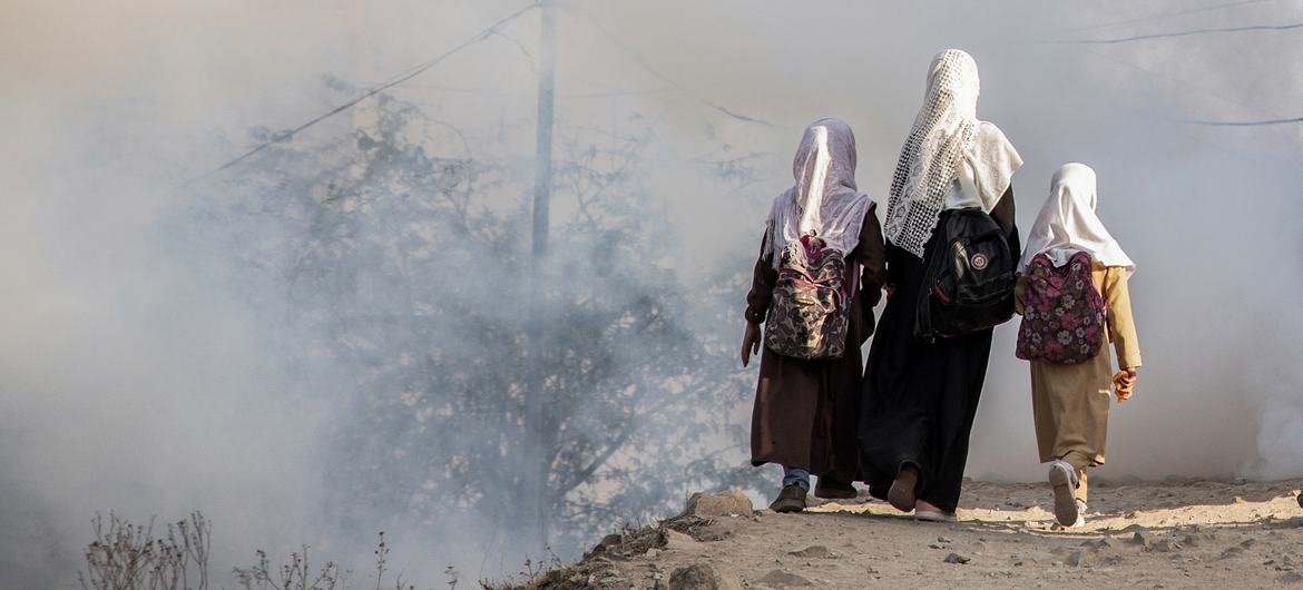 Three sisters walk to their school close to a fighting zone in Taizz, Yemen, February 2021. Three sisters walk to their school close to a fighting zone in Taizz, Yemen, February 2021.