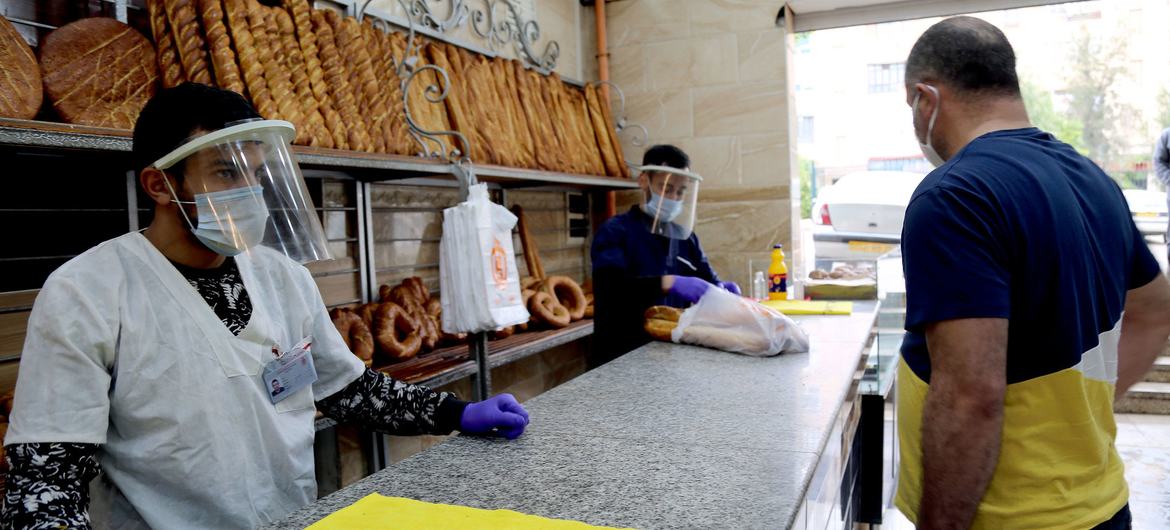 Shop workers sell bread at a bakery in Constantine, Algeria during the COVID-19 pandemic. Shop workers sell bread at a bakery in Constantine, Algeria during the COVID-19 pandemic.