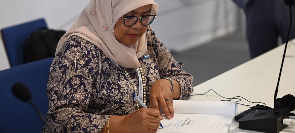 Maimunah Mohd Sharif, Executive Director of UN-Habitat, signs a copy of the World Cities Report 2022 at the World Urban Forum in Katowice, Poland. Maimunah Mohd Sharif, Executive Director of UN-Habitat, signs a copy of the World Cities Report 2022 at the World Urban Forum in Katowice, Poland.