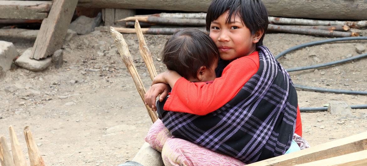 A child looks after his younger sibling in Myanmar. A child looks after his younger sibling in Myanmar.