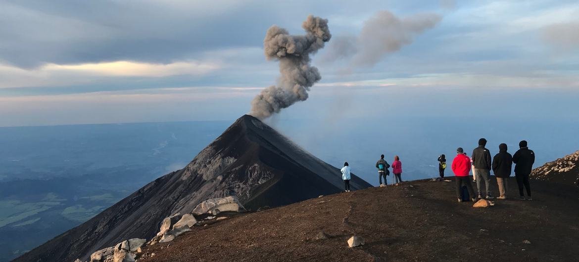 Tourists overlooking Volcano Fuego erupting from Volcano Acatenango, Guatemala. Tourists overlooking Volcano Fuego erupting from Volcano Acatenango, Guatemala.