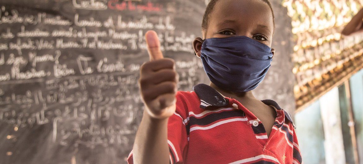 An eight-year-old child in Nouakchott, Mauritania, gives a thumbs-up after an awareness session on preventing COVID-19.