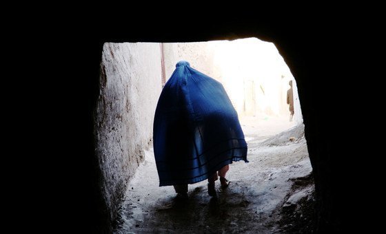 An Afghan woman covers a child under her Borqa while passing through a tunnel in Herat, Afghanistan. An Afghan woman covers a child under her Borqa while passing through a tunnel in Herat, Afghanistan.