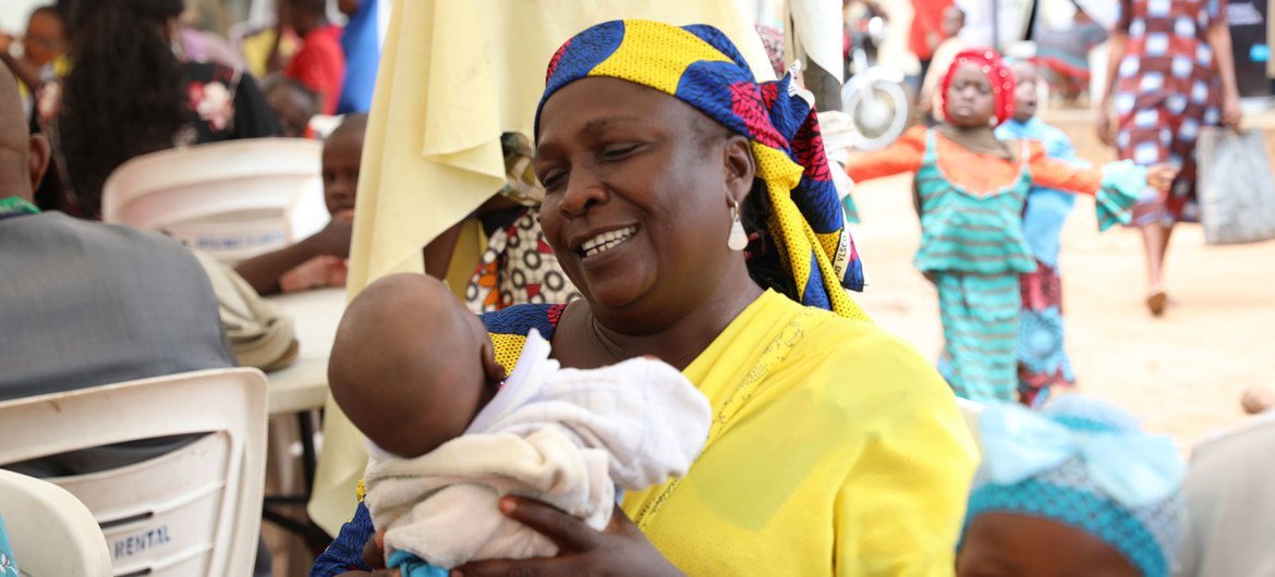 A displaced Nigerian woman is happy that the children she delivered will get birth certificates . A displaced Nigerian woman is happy that the children she delivered will get birth certificates .