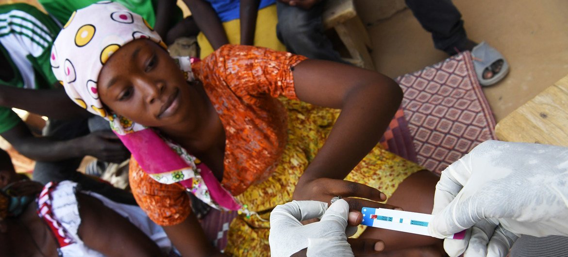 In Ndjamena, Chad, a seventeen-year-old girl smiles when she learns she's HIV negative. In Ndjamena, Chad, a seventeen-year-old girl smiles when she learns she's HIV negative.