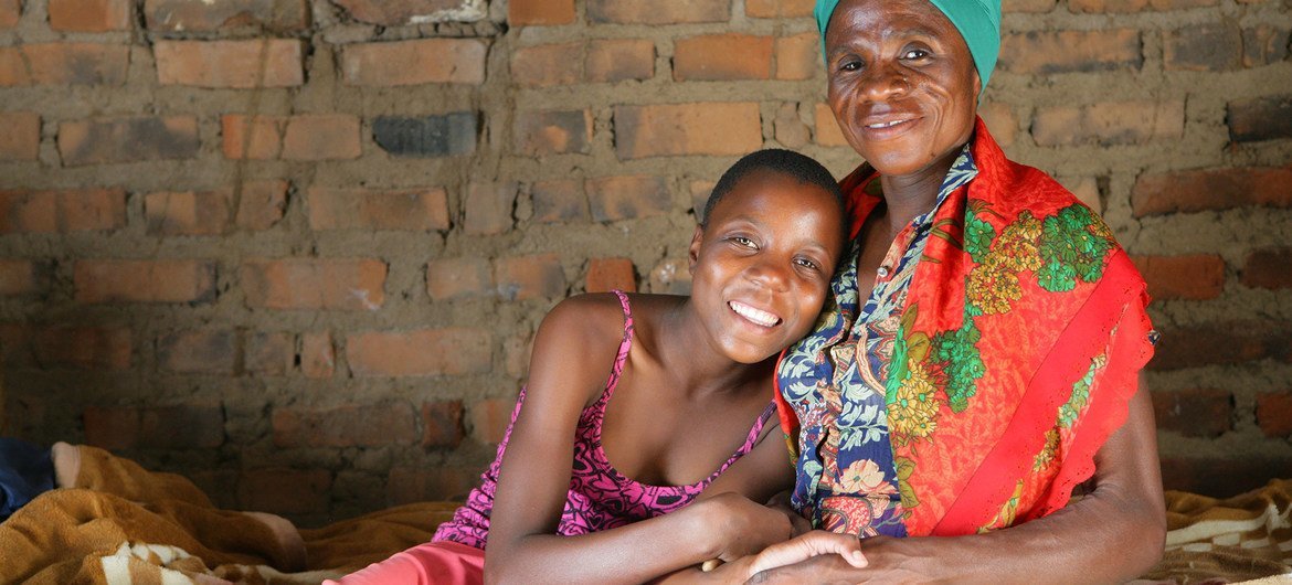 A HIV-positive woman sits at home with her granddaughter in Mangwe, Zimbabwe. A HIV-positive woman sits at home with her granddaughter in Mangwe, Zimbabwe.